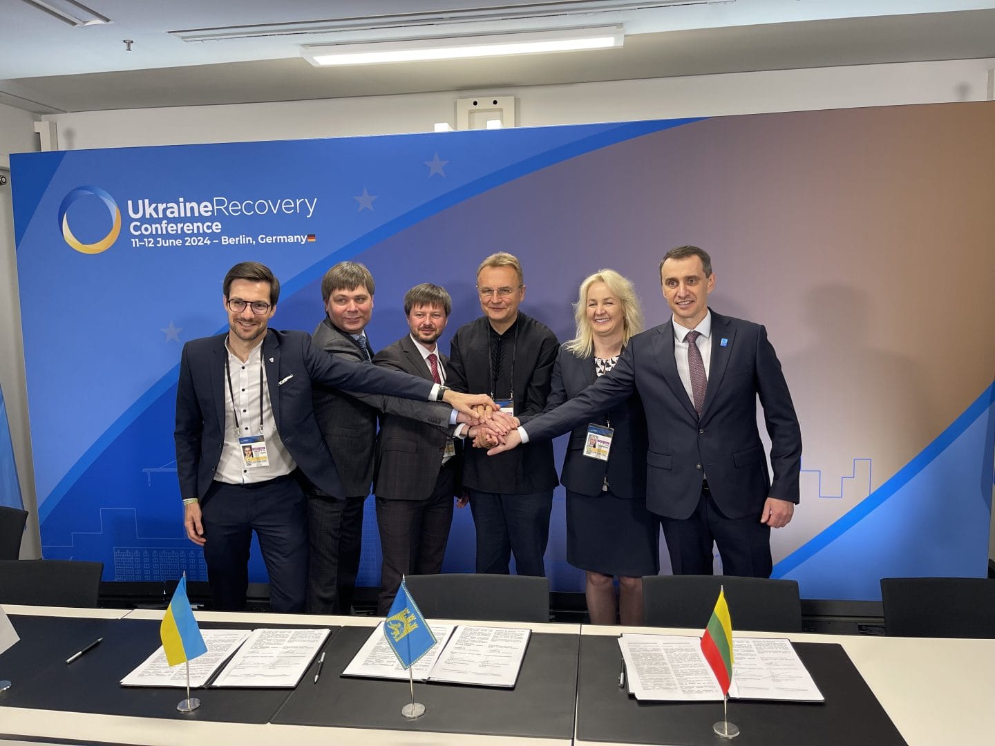 Photo from Ukraine Recovery Conference in Berlin, where a decisive role of local governance and partnerships in recovery of Ukraine was underlined. In the photo Mayor of Lviv Andriy Sadovyi signs a cooperation agreement with Lithuanian and German partners to support the UNBROKEN national rehabilitation center in Lviv